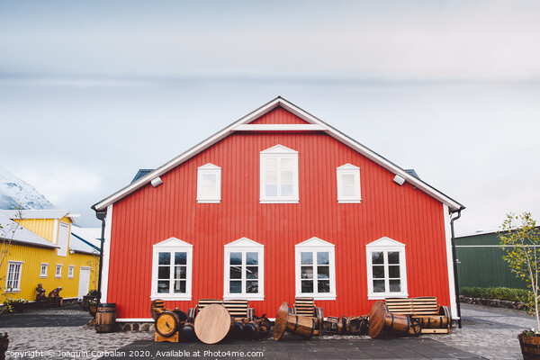 Nice house with red wooden planks in iceland. Picture Board by Joaquin Corbalan