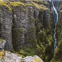 Buy canvas prints of Panoramic photos of famous Icelandic waterfalls on cloudy days with geological formations. by Joaquin Corbalan