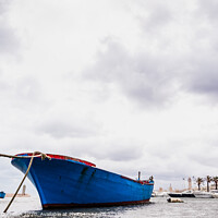 Buy canvas prints of Small boat moored to Bari port, Italy, during a storm at sea. by Joaquin Corbalan
