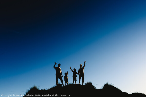 Silhouette of a happy family on top of a hill waving at sunset. Picture Board by Joaquin Corbalan