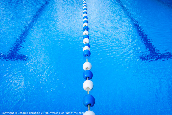 Detail of the water of a pool with beacons to separate the swimming streets. Picture Board by Joaquin Corbalan
