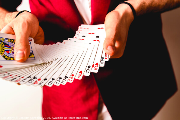 Hands of magician doing tricks with a deck of cards. Picture Board by Joaquin Corbalan