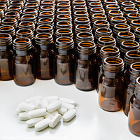 Buy canvas prints of Heap of pills with empty medicine containers, pharmaceutical industry concept. by Joaquin Corbalan