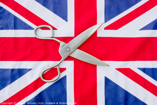 A woman cuts with scissors the British flag in protest. Picture Board by Joaquin Corbalan
