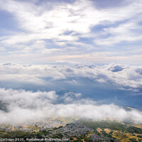 Buy canvas prints of Scene of a winter cloudy sky from the top of a mountain peak. by Joaquin Corbalan
