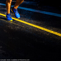 Buy canvas prints of A lonely runner trains on wet asphalt at sunset, copy space. by Joaquin Corbalan