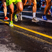 Buy canvas prints of Muscled legs of a group of several runners training running on asphalt by Joaquin Corbalan