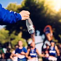 Buy canvas prints of Drinking water is important when we exercise like running to avoid becoming dehydrated. by Joaquin Corbalan