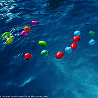 Buy canvas prints of Colorful plastic water balloons floating in a pool to play on vacation to cool off. by Joaquin Corbalan