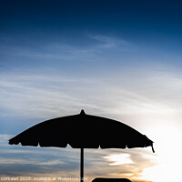 Buy canvas prints of Silhouette of beach umbrella against backlight on a hot summer day. by Joaquin Corbalan
