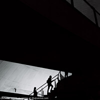 Buy canvas prints of Silhouettes of people inside a building crossing stairs and walkways. by Joaquin Corbalan