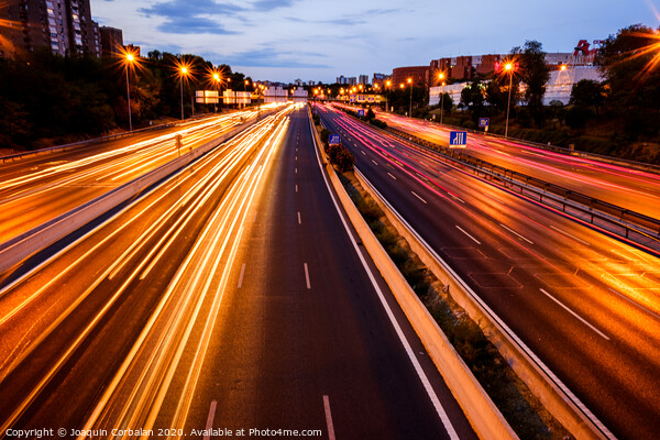 Trails of car lights on a large road at night. Picture Board by Joaquin Corbalan