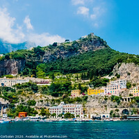 Buy canvas prints of View from the sea of this picturesque Italian Mediterranean city, with old and colorful houses built on the side of a hill. by Joaquin Corbalan