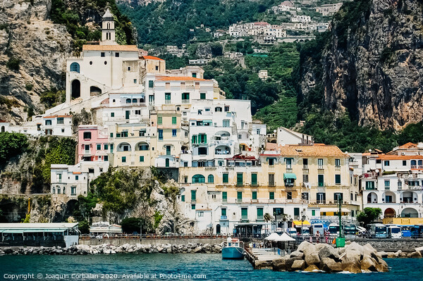 Sorrento, Italy - June 5, 2019: View from the sea of this picturesque Italian Mediterranean city, with old and colorful houses built on the side of a hill. Picture Board by Joaquin Corbalan