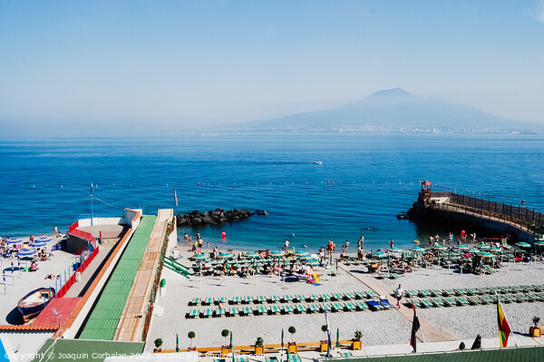  A beach with sunbathers in Sorrento, with background of unfocused view of Vesuvius volcano. Picture Board by Joaquin Corbalan