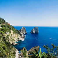 Buy canvas prints of Natural rock arches and cliffs on the coast Sorrento and Capri, Italian islands with crystal clear waters where tourist boats crowd to photograph them in summer. by Joaquin Corbalan