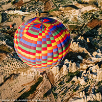 Buy canvas prints of Travelers and tourists flying over mountains at sunset in a colorful aerostat balloon in Goreme, the Turkish cappadocia. by Joaquin Corbalan
