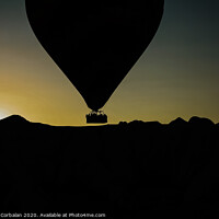 Buy canvas prints of Silhouette of travelers and tourists flying over mountains at sunset in an aerostatic balloon. by Joaquin Corbalan