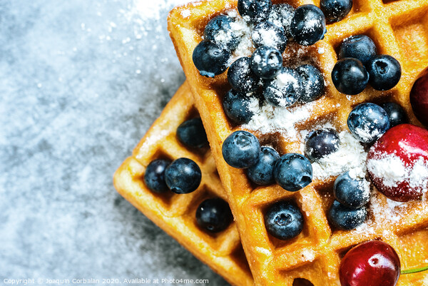 Close-up of a waffle with blueberries for breakfast during a vacation at a vegetarian restaurant. Picture Board by Joaquin Corbalan