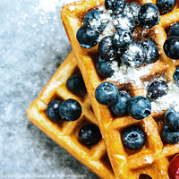 Buy canvas prints of Close-up of a waffle with blueberries for breakfast during a vacation at a vegetarian restaurant. by Joaquin Corbalan