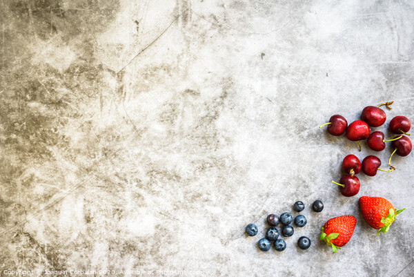 Clean background with a lot of negative space for healthy food, with red fruits on one side. Picture Board by Joaquin Corbalan