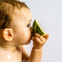 Buy canvas prints of Baby in profile eating a watermelon drooling and getting dirty with the sticky juice of the fruit. by Joaquin Corbalan