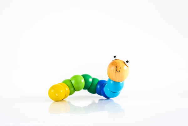 Toy caterpillar with smile, to illustrate concepts of infant intestinal health. Picture Board by Joaquin Corbalan