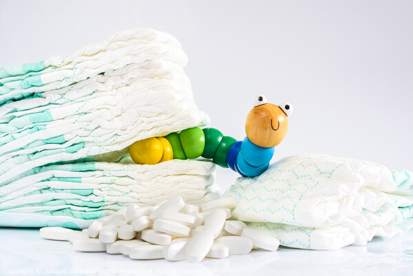 Enterobiasis is a infections of worms, Enterobius vermicularis or pinworms, which affects children and babies. A toy worm with some diapers and pills. Picture Board by Joaquin Corbalan