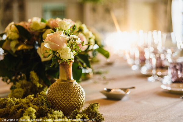 Beautiful vintage vases with roses as centerpieces of decorating tables of a wedding. Picture Board by Joaquin Corbalan