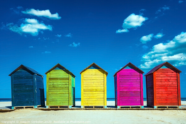 Colorful wooden changing huts on a beach, with nice background of clear blue sky on the coast. Picture Board by Joaquin Corbalan