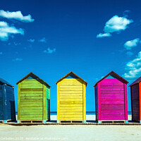 Buy canvas prints of Colorful wooden changing huts on a beach, with nice background of clear blue sky on the coast. by Joaquin Corbalan