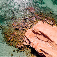 Buy canvas prints of Aerial view of a natural rock jetty on the Mediterranean coast with transparent turquoise waters. by Joaquin Corbalan
