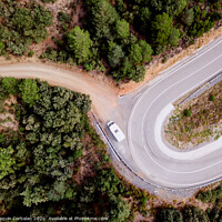 Buy canvas prints of Aerial view of an adventure travel motorhome on a mountain road through a forest by Joaquin Corbalan