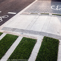 Buy canvas prints of New bike lanes next to recharging stations for electric vehicles on paved asphalt. by Joaquin Corbalan