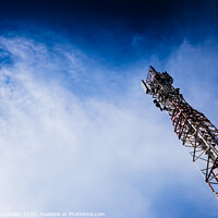 Buy canvas prints of A tall modern communications tower provides telecommunications service to a city, negative space on blue background. by Joaquin Corbalan