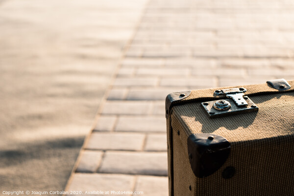 Close-up detail of an old vintage suitcase with blur background with copy space. Picture Board by Joaquin Corbalan