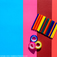 Buy canvas prints of Colored background seen from above with plastic bars to use in crafts and stationery. by Joaquin Corbalan