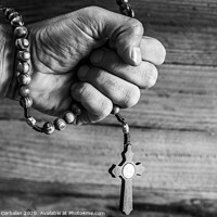 Buy canvas prints of Hand of a religious person holds a Christian rosary during his prayers, unfocused background of woods in black and white. by Joaquin Corbalan