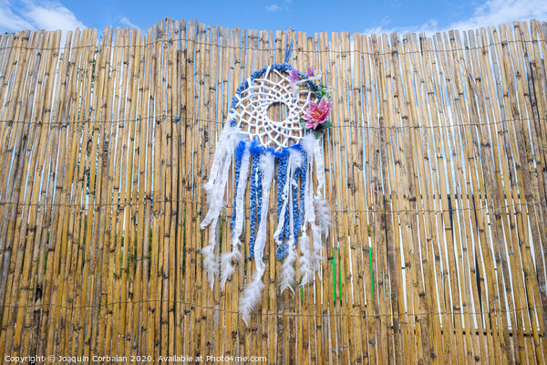 Vintage indigenous decoration hanging from a wall of old reeds, intense colors. Picture Board by Joaquin Corbalan
