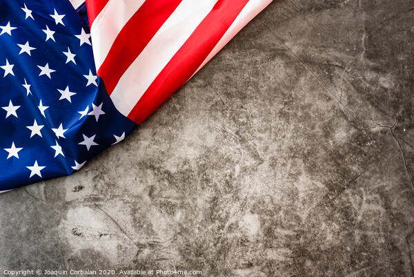 Striking colored American flag isolated in a corner on a stone gray background. Picture Board by Joaquin Corbalan