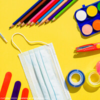 Buy canvas prints of School supplies next to a face mask, flat lay background back to school. by Joaquin Corbalan