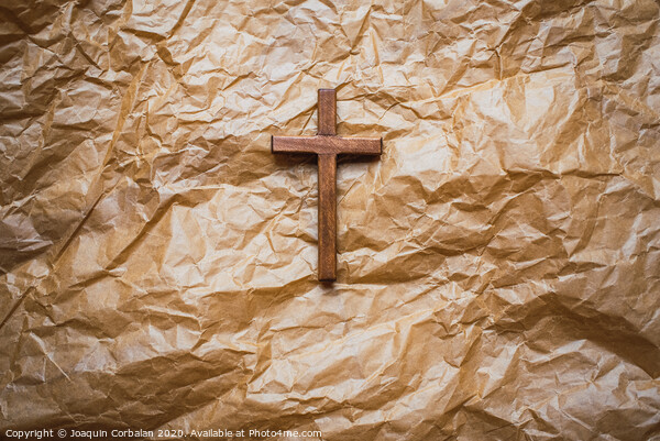 Simple wooden religious cross on brown paper background. Picture Board by Joaquin Corbalan