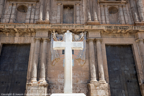 Cross carved in white stone, erected in front of a Christian religious church. Picture Board by Joaquin Corbalan