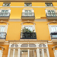 Buy canvas prints of Bright facade of a typical old Mediterranean building painted in bright colors and warm tones. by Joaquin Corbalan