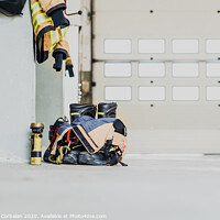 Buy canvas prints of Detail of the work suit of a firefighter prepared for action next to the material to extinguish fires safely. by Joaquin Corbalan