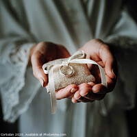 Buy canvas prints of Wedding rings on a pad held by the delicate hands of a bride. by Joaquin Corbalan