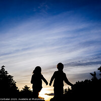 Buy canvas prints of Silhouette of two children running through the field on a winter sunset. by Joaquin Corbalan