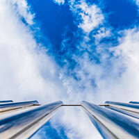 Buy canvas prints of Fence with tall metal bars pointing to the blue sky with perspec by Joaquin Corbalan