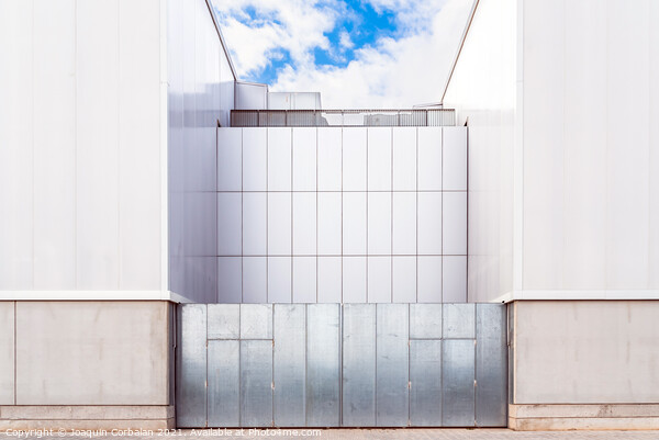 Facade of a door of an industrial warehouse made of gleaming alu Picture Board by Joaquin Corbalan