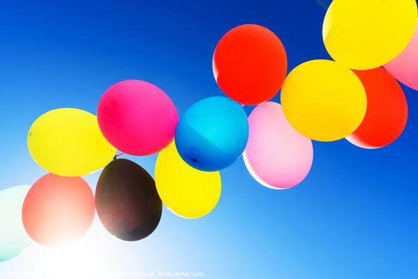 Colorful balloons inflated against the sun, festive and joyful c Picture Board by Joaquin Corbalan